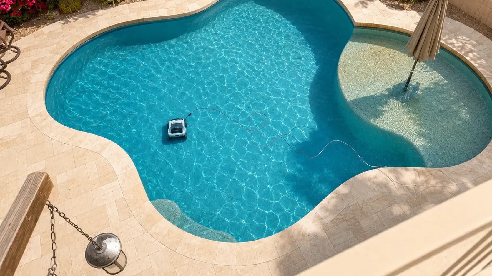 Polaris VRX iQ+ robotic pool cleaner working in a bright Scottsdale sports pool with a Baja shelf and power cable visible.
