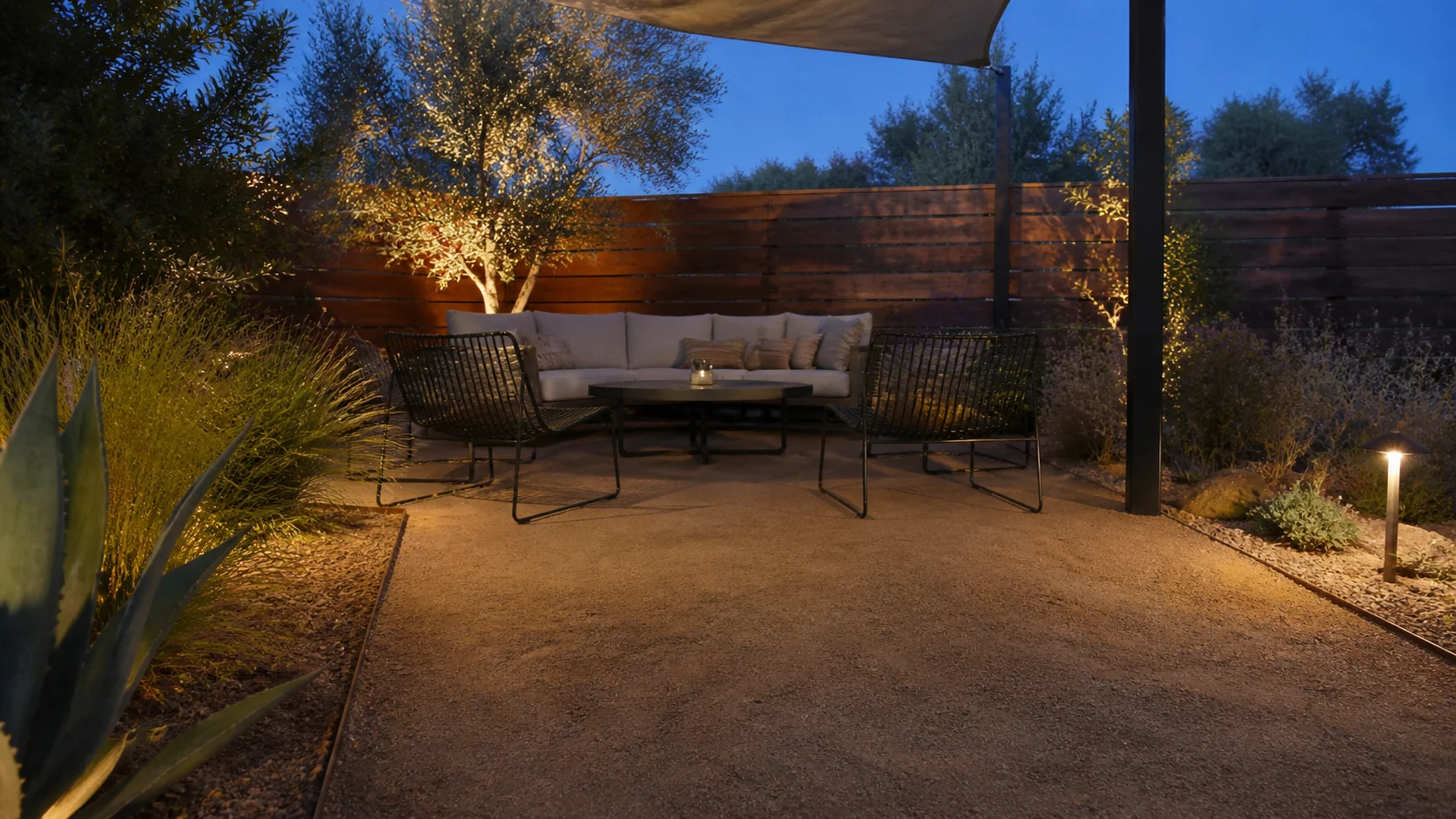 Decomposed granite seating area with shade and low-water landscaping.